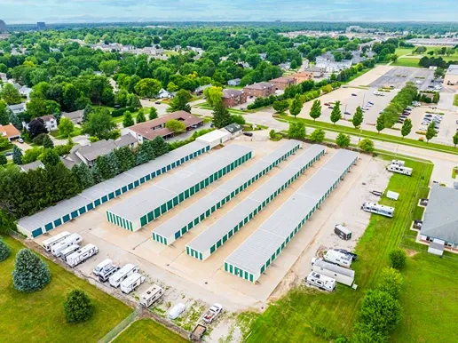 Aerial view of self storage facility with multiple drive-up unit buildings along main road